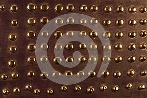Brown wood background with metal gold buttons, high resolution