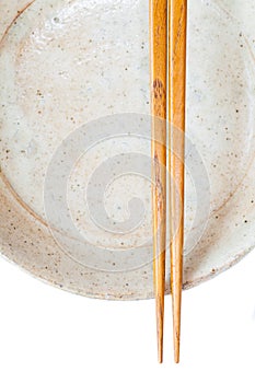 Brown wood chopsticks and white ceramic