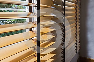 Brown wood curtain control lighting at window