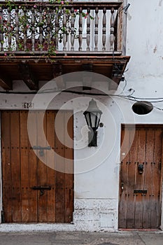 Brown wood door of a white colonial house front in