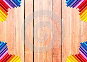 Brown wood plank with colorful pencil at the corner