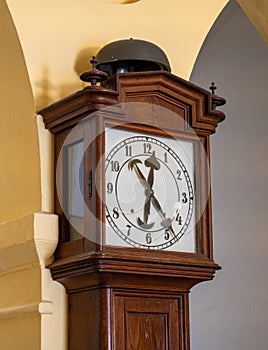 brown wood retro floor clock against the wall