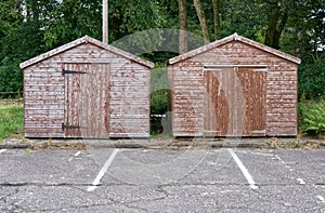 Brown wood sheds in rural countryside car park