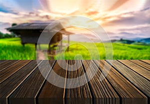 Brown wood table in summer farm green landscape.