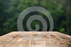 Brown wood table top on a green blur abstract background