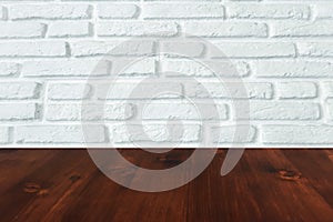 Brown wood table with white brick wall texture background