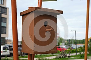 Brown wooden bird house in the city