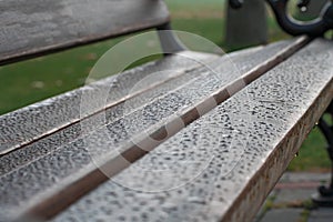 Brown wooden brench  with water drops after rain