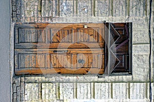 Brown wooden door on an old brick building