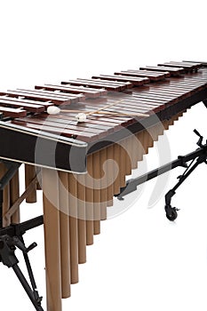 A brown wooden marimba on a white background