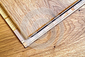 Brown wooden parquet floor planks installation , close up. Carpentry concept.