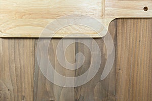 Brown wooden plate on pine plank