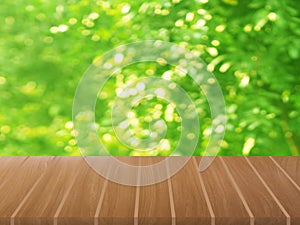 Brown wooden table on blurred greenery nature background, Natural template Foliage green leaves texture backlight bokeh sunshine