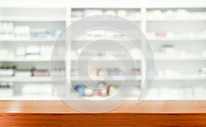 Brown wooden tabletop with blurred pharmacy