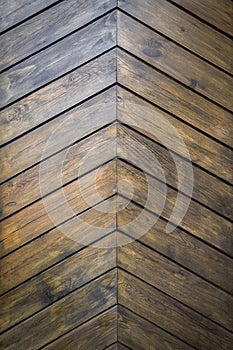 Brown wooden wall made of varnished panels with big knots as a natural background