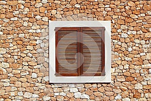 Brown wooden window in masonry wall photo
