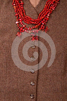 Brown woolen clothes with necklace.