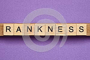 Brown word rankness in small square wooden letters