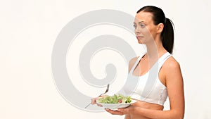 Brownhaired woman eating a salad