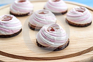Brownie, white-pink marshmallows, jam, cookies, chocolate on a wooden background. Close-up