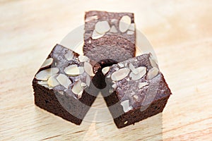 Brownies cake on the table - chocolate cake slice with nut on wooden background