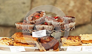 Brownies and other fruit pastry at bakery stand at farmers market