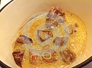 Browning meat in hot oil and butter photo