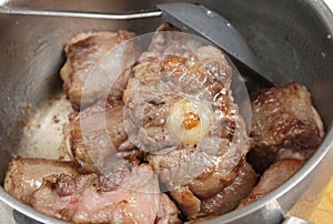 Browning oxtail in a pan