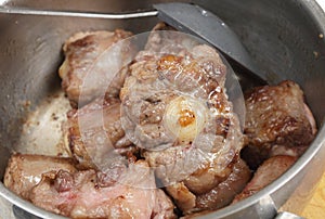 Browning oxtail in a pan photo