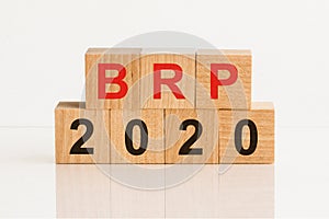 BRP 2020 word written on wood block. Faqs text on table, concept