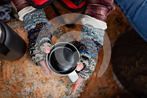 Brrr Its time for coffee. High angle shot of an unrecognisable woman drinking a warm beverage while camping in the photo