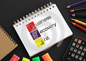 BRU - Business Recovery Unit acronym, business concept background on notepad