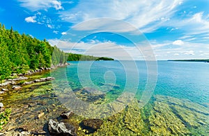 Bruce Peninsula park landscape, grounds with tranquil, turquoise clean water on sunny summer beautiful day