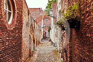 Bruges Belgium. Antique brick walls along narrow photo