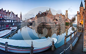 Bruges, Belgium iconic medieval houses, towers and Rozenhoedkaai canal. Classic postcard view of the historic city center. Often r