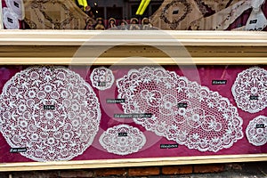 BRUGES, BELGIUM - JUNE 10, 2014: Famous handmade lace for sale in Bruges, Belgium