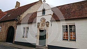 Bruges, Belgium - May 12, 2018:  Roofs And Windows Of Old Authentic Brick Houses On Street Gearwijnstraat