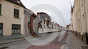 Bruges, Belgium - May 12, 2018:  Roofs And Windows Of Old Authentic Brick Houses On Street Vrijdagmarkt