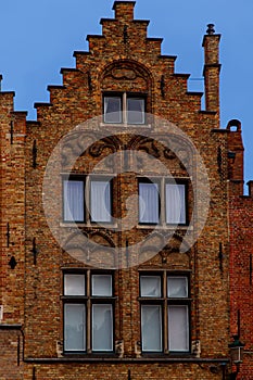 Bruges, Flanders, Belgium, Europe - October 1, 2019. Details of facades medieval old brick houses on the ancient streets in