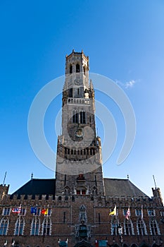 Brugge Belfry tower facade of famous tourist destination at Grote markt square in Bruges