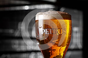 Brugge, Belgium - Ocober 20, 2019: Glass of Belgium Petrus Beer in bar