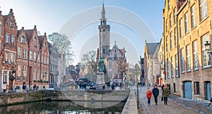 Brugge, West Flanders Belgium - December 2018: Spiegelrei canal, Jan Van Eyck Square and Poortersloge The Burghers` Lodge