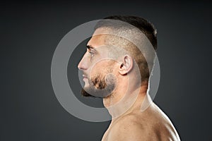 Bruised fighter on gray background