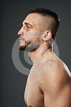 Bruised fighter on gray background