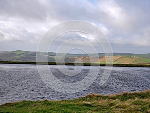 Brun Clough reservoir in the pennines with distant moorland photo