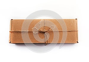 The brun squared present box with jute rope on a white background