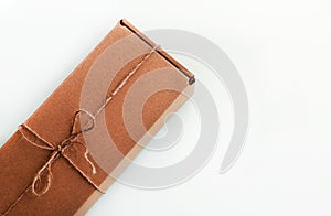 The brun squared present box with jute rope on a white background photo