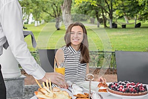 Brunch Choice Dining Food Options Eating Concept. Couple having a brunch with sparkling wine outdoors.