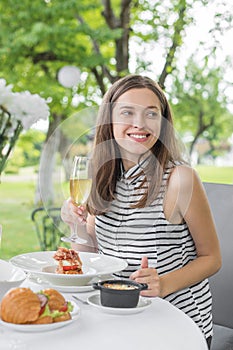 Brunch Choice Dining Food Options Eating Concept. Couple having a brunch with sparkling wine outdoors.