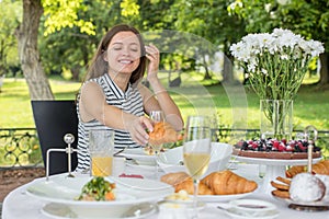 Brunch Choice Dining Food Options Eating Concept. Couple having a brunch with sparkling wine outdoors.